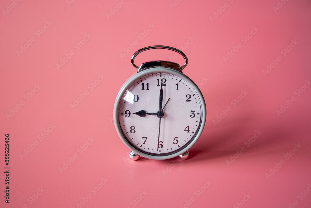Alarm clock on pink background. Alarm clock on pink background.