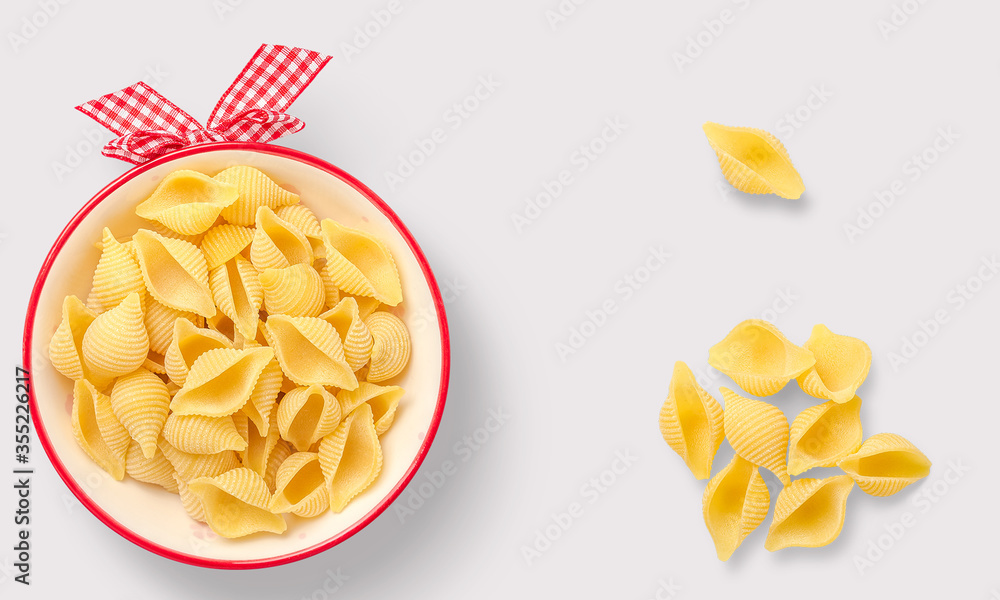 Pasta in a wooden bowl on a white background Pasta in a wooden bowl on a white background