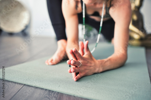 Obraz na plátně Nice yoga teacher woman in a studio indoors
