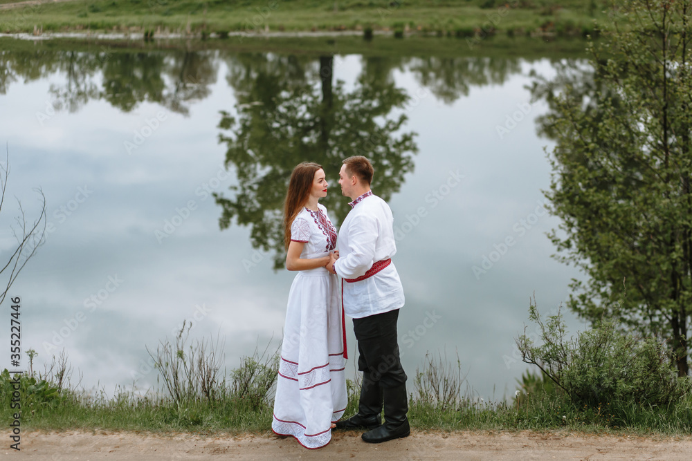 A couple in love in Russian traditional dresses A couple in love in Russian traditional dresses