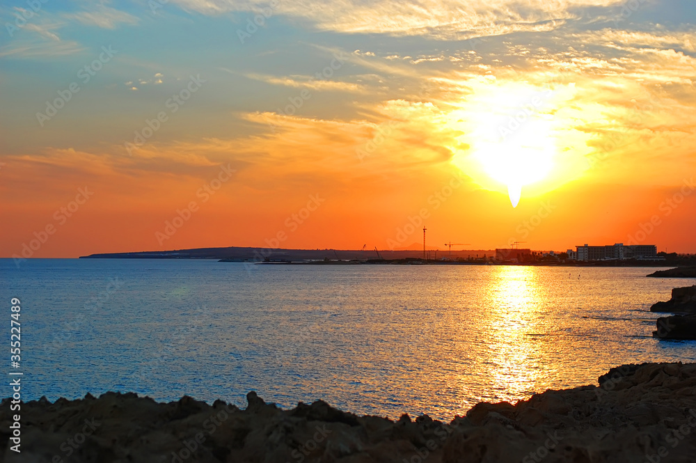 Sea sunset on the coast of Cyprus. Tourism, travel. Horizontal photo.