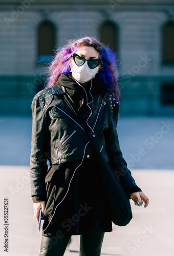 Virus mask hipster woman wearing face protection in prevention for coronavirus in Belgrade. Lady walking in public space, street.