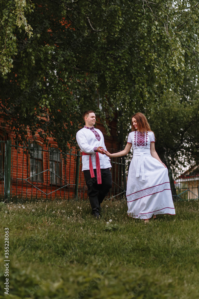 A couple in love in Russian traditional dresses A couple in love in Russian traditional dresses