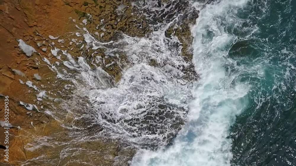 Nostalgic aerial video, in slow motion of the sea, the waves smoothly roll on the rocky shores of the Pacific Atlantic Ocean. Nostalgic aerial video, in slow motion of the sea, the waves smoothly roll on the rocky shores of the Pacific Atlantic Ocean.