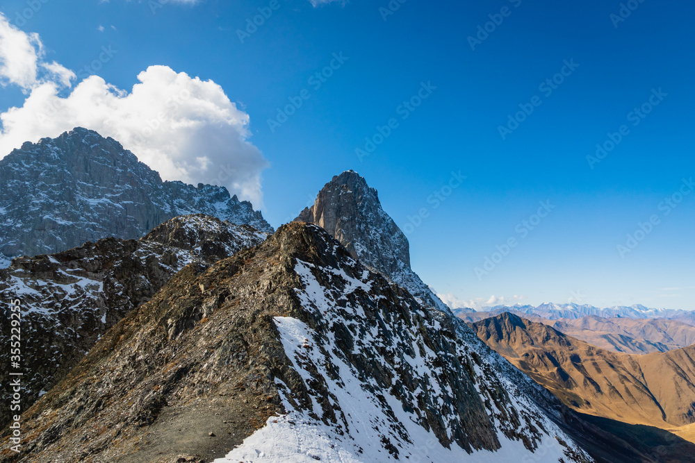 dramatic mountain landscape in Juta trekking area landscape with snowy  mountains at dawn -  popular trekking  in the Caucasus mountains, Kazbegi region, Georgia.