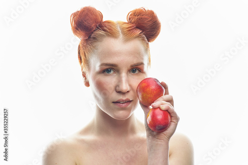 Portrait of a young redhead girl with apples in her hands, with different emotions. Isolated on a white background.