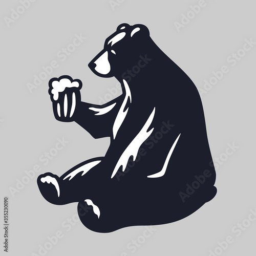 Silhouette of bear with pint of craft beer in paw