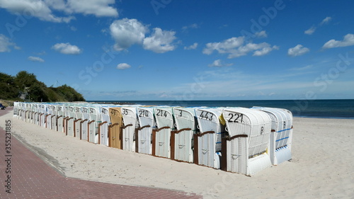 Many beach chairs stand side by side on the long, fine sandy beach on the Baltic Sea in Hohwacht, Schleswig-Holstein, Germany, Europe 