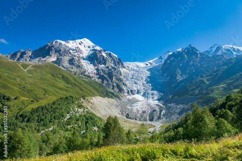 Svaneti landscape with glacier and snow-capped mountain in the back near Mestia village in Svaneti region, Georgia. © uskarp2