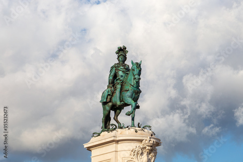 Lisbon Portugal  historical bronze equestrian statue of King Jose I  finished 1775  on Praca do Comercio square. Giant cumulus cloud as a backdrop  on a sunny afternoon.