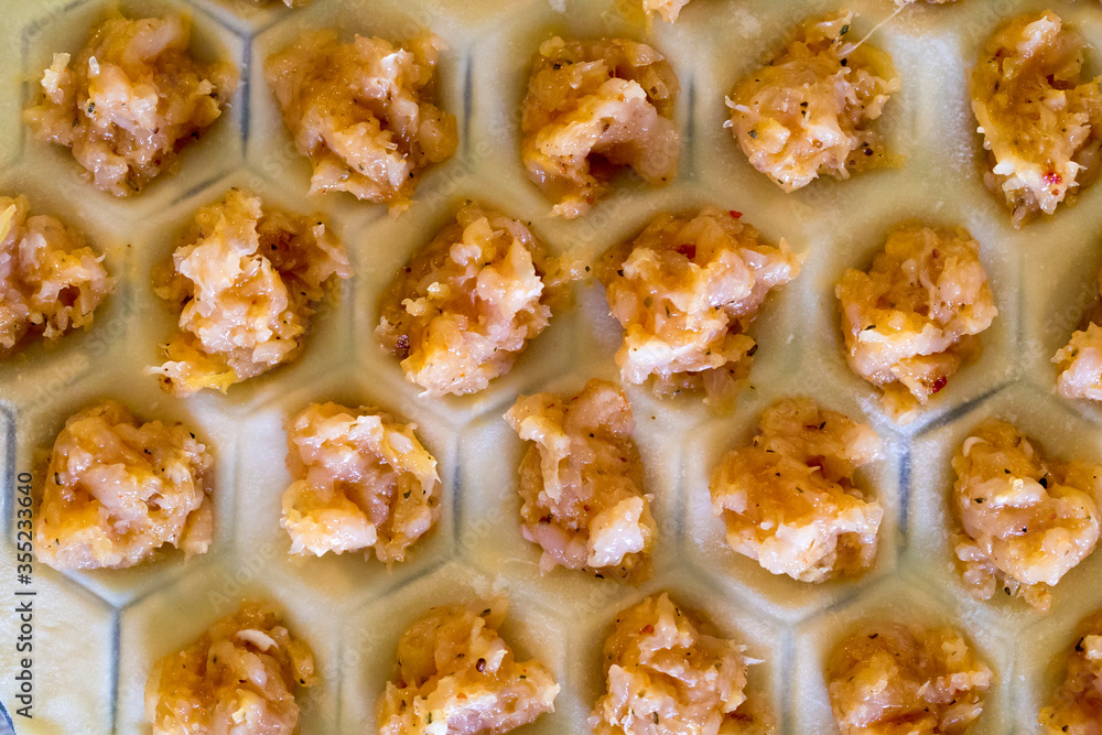 Raw homemade dumplings. Chicken meat with spices on the dough. The process of making dumplings Raw homemade dumplings. Chicken meat with spices on the dough. The process of making dumplings