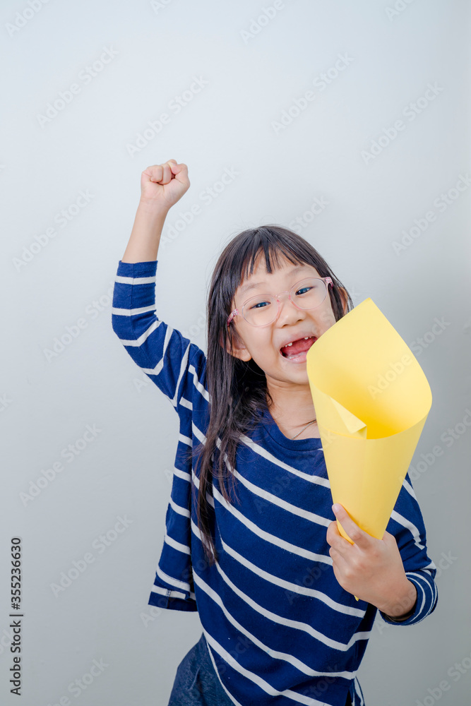Lettle girl shouting into megaphone with white background. Lettle girl shouting into megaphone with white background.