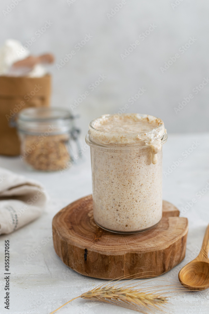 Active bubbly sourdough bread starter, healthy fermentation process on light table Active bubbly sourdough bread starter, healthy fermentation process on light table