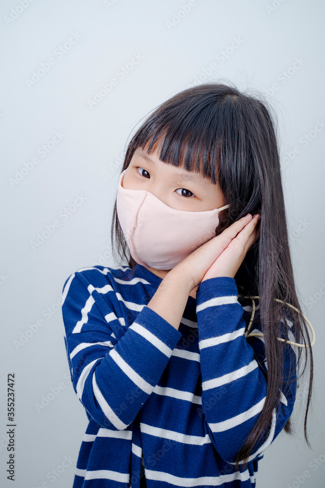 Coronavirus Covid-19 pm2.5.Online education.Little asian girl wearing face mask show thumbs up for good and happy at home. Covid-19 coronavirus.Stay home.Social distancing.New normal behavior. Coronavirus Covid-19 pm2.5.Online education.Little asian girl wearing face mask show thumbs up for good and happy at home. Covid-19 coronavirus.Stay home.Social distancing.New normal behavior.