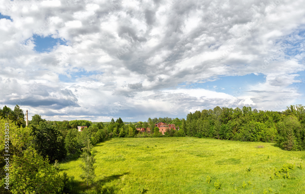 Panoramic landscape with red brick house ruins in the park on cloudy summer afternoon Panoramic landscape with red brick house ruins in the park on cloudy summer afternoon