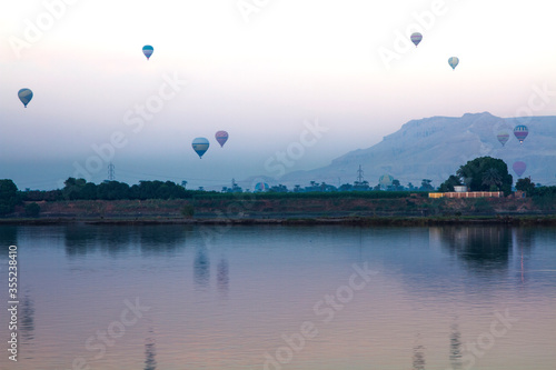 Nile river at sunrise with hot air balloons in Luxor, Egypt. 