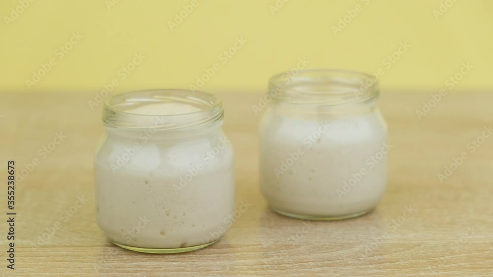 Yeast in a glass jar on a yellow background, fermentation Yeast in a glass jar on a yellow background, fermentation