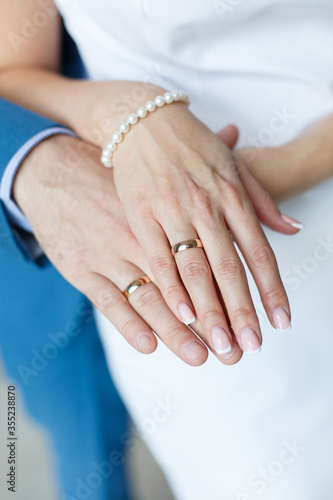 Bride's and Groom's hands with wedding rings
