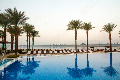 Nile river at sunrise with hot air balloons in Luxor, Egypt.

