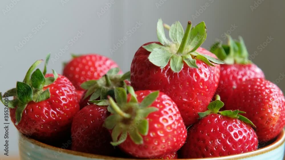 Fresh organic strawberry in a bowl rotating. Close up, slow motion Fresh organic strawberry in a bowl rotating. Close up, slow motion