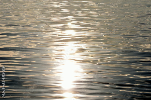 calm golden sunshine reflection on sea surface background