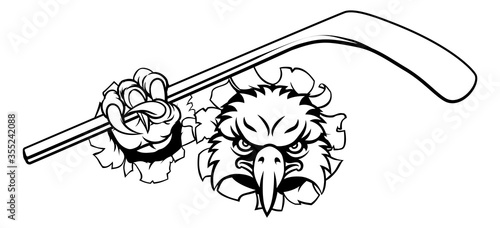 An eagle ice hockey player animal sports mascot holding a hockey stick