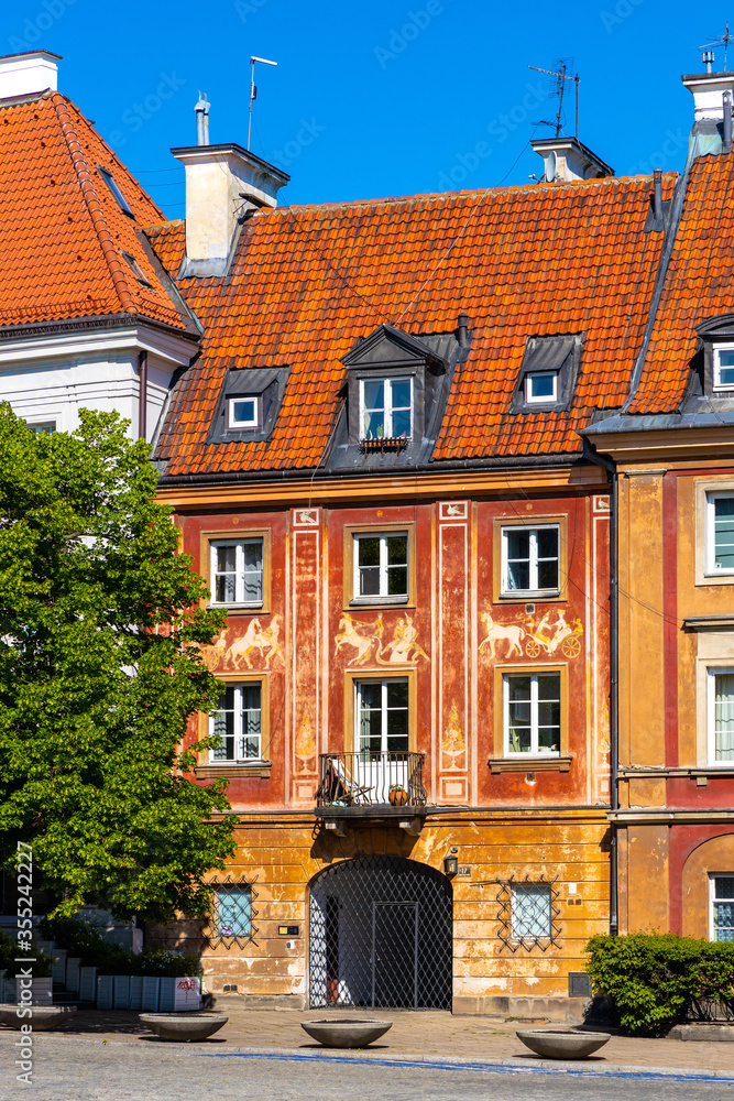 Fototapeta premium Colorful renovated tenement houses of historic New Town quarter - Nowe Miasto - at Rynek Nowego Miasta New Town Market Square in Warsaw, Poland