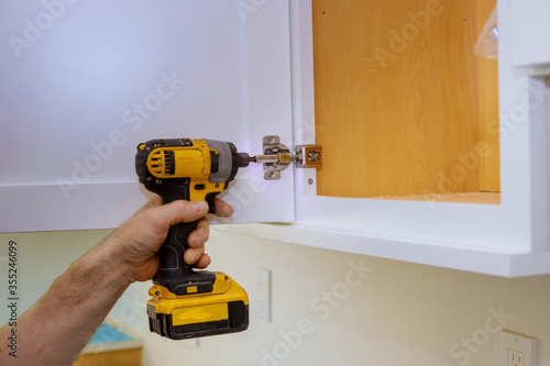 Modern fixing cabinet door hinge adjustment on kitchen cabinets