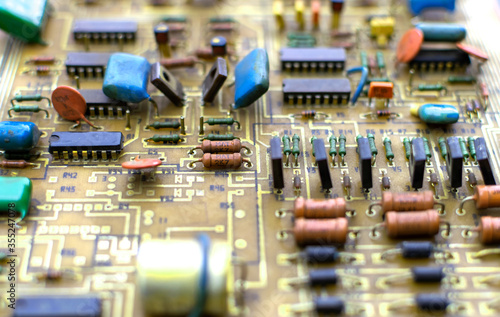 Old vintage printed circuit board with electronic components.