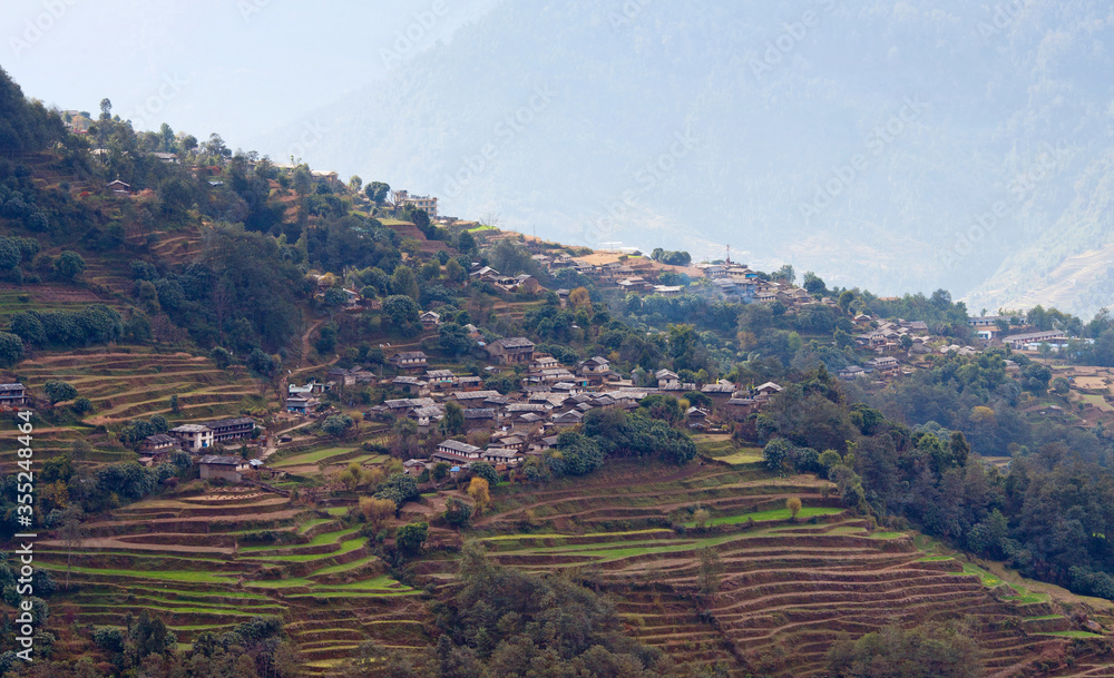 Panorama of Ghandruk village over terraced rice fields on the way to Annapurna Base Camp in the Nepal Himalayas