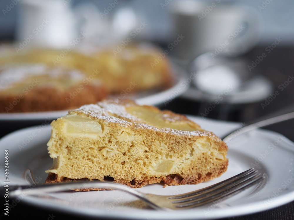 Home cooking.Sponge cake with pineapple on a dark background. Home cooking.Sponge cake with pineapple on a dark background.