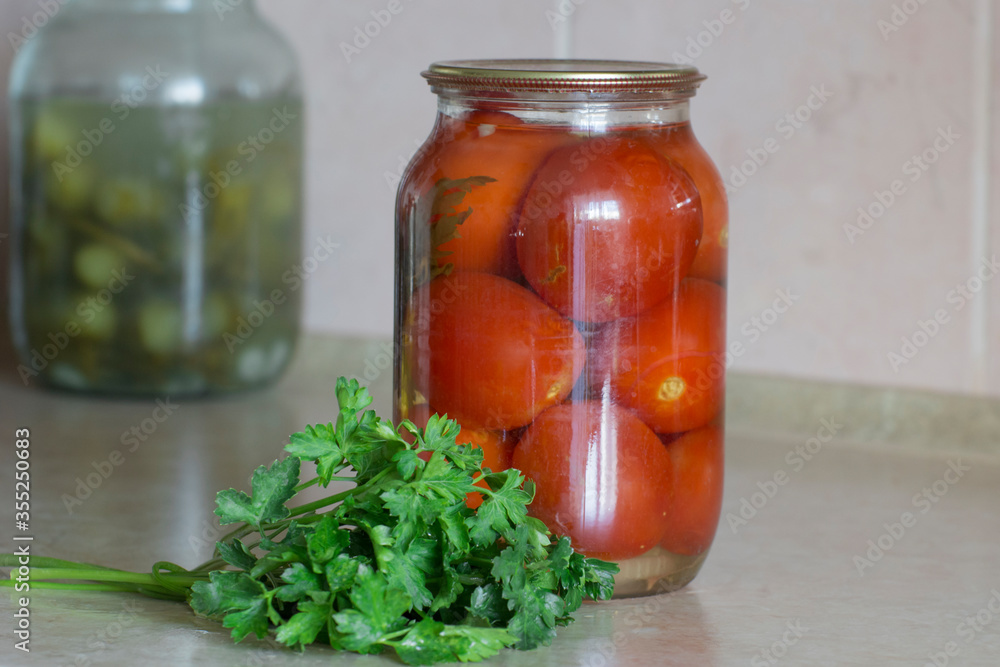 Glass jar with canned tomatoes. Preservation of vegetables at home. Organic products. Glass jar with canned tomatoes. Preservation of vegetables at home. Organic products.
