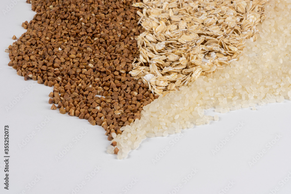 Mixed cereals, buckwheat, oatmeal, rice on the background Mixed cereals, buckwheat, oatmeal, rice on the background