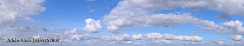September is the autumn sky. Panoramic photo of dense clouds flying low above the ground.