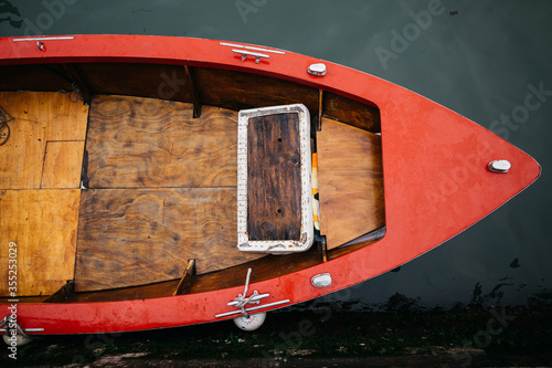 Beautiful old retro boat on red water.