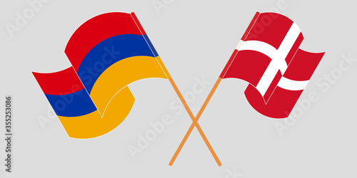 Crossed and waving flags of Armenia and Denmark