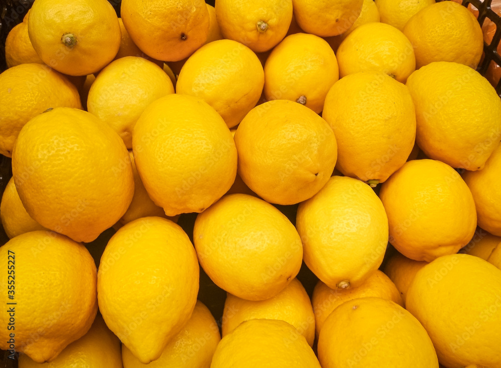 Organic Lemons In Supermarket. Yellow Citrus Fruit Lemon background. Organic Lemons In Supermarket. Yellow Citrus Fruit Lemon background.