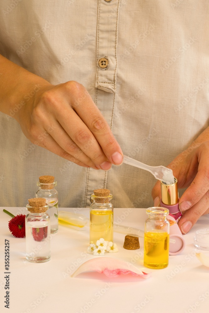Beautiful and useful photo of a woman who makes homemade natural cosmetics and lipsticks from oils, essential oils, peppermint, rose water and aloe vera gel Beautiful and useful photo of a woman who makes homemade natural cosmetics and lipsticks from oils, essential oils, peppermint, rose water and aloe vera gel