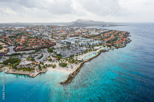 Aerial view of coast of Curacao in the Caribbean Sea with turquoise water, cliff, beach and beautiful coral reef