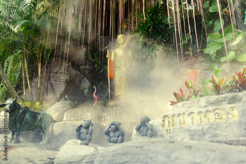 Buddah statue in a temple with spry and 3 monkeys photo