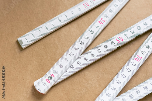 folding ruler measuring tool on a brown background. Kraft paper background