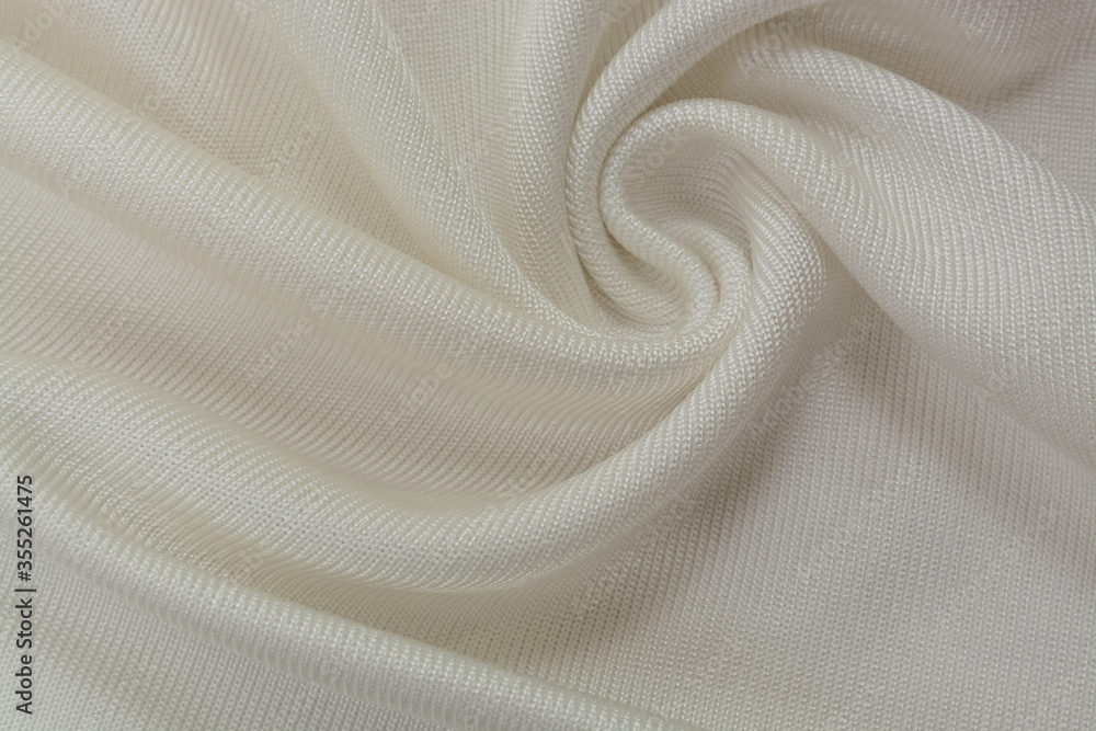 Background texture of ivory fabric, soft napped insulating fabric made of polyester, wavy pattern, top view Background texture of ivory fabric, soft napped insulating fabric made of polyester, wavy pattern, top view