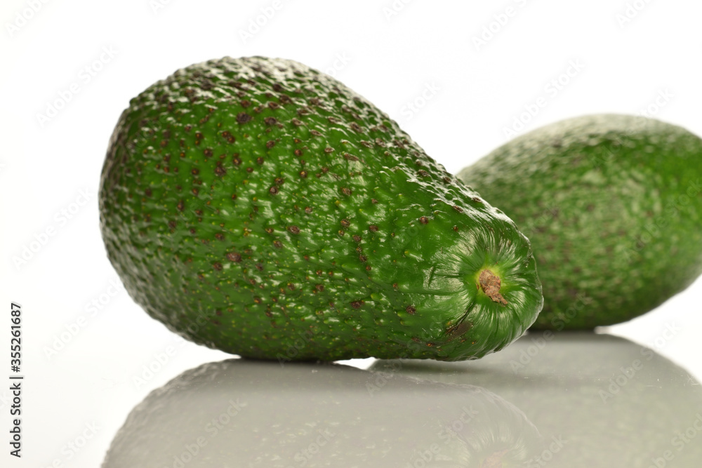 Green fresh ripe tasty avocado, close-up, on a white background. Green fresh ripe tasty avocado, close-up, on a white background.