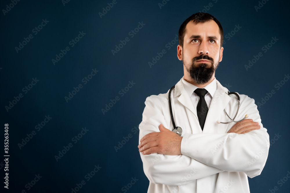 Male doctor with stethoscope in medical uniform looking confident hero-shot Male doctor with stethoscope in medical uniform looking confident hero-shot