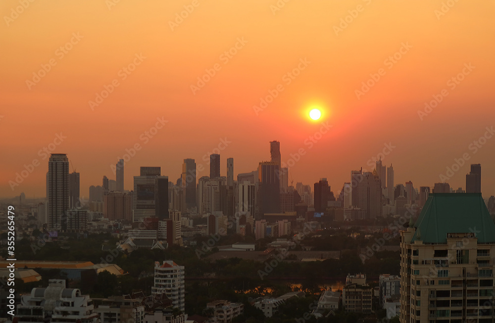 Stunning view of the bright sun setting over the city