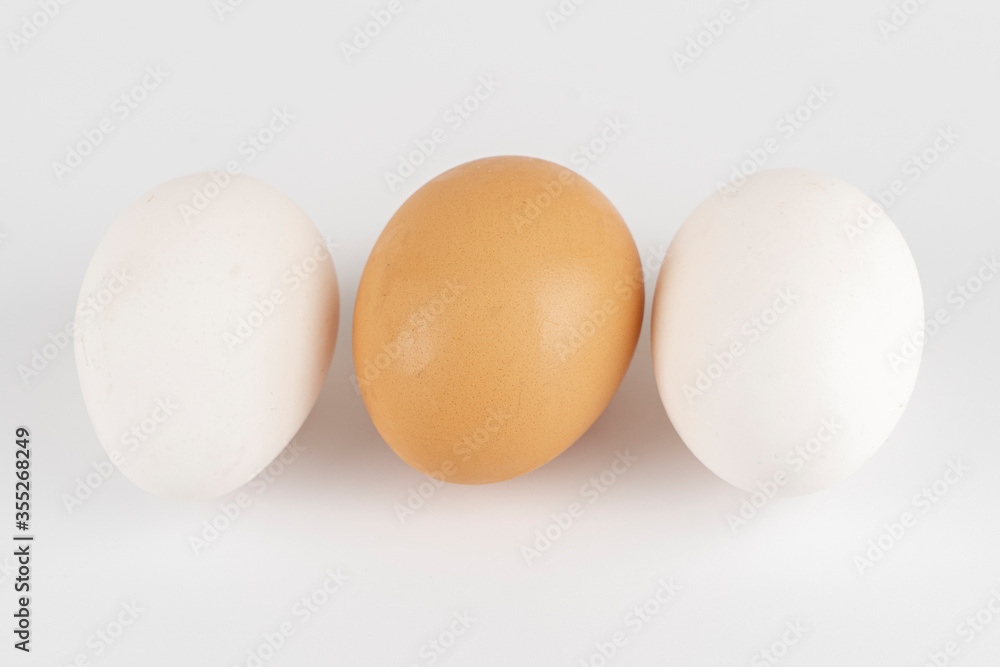 White and brown chicken eggs on a background close-up White and brown chicken eggs on a background close-up