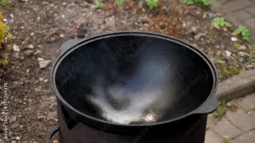 A man cooks fried meat in a pan with sauce and beer. 4K shooting A man cooks fried meat in a pan with sauce and beer. 4K shooting