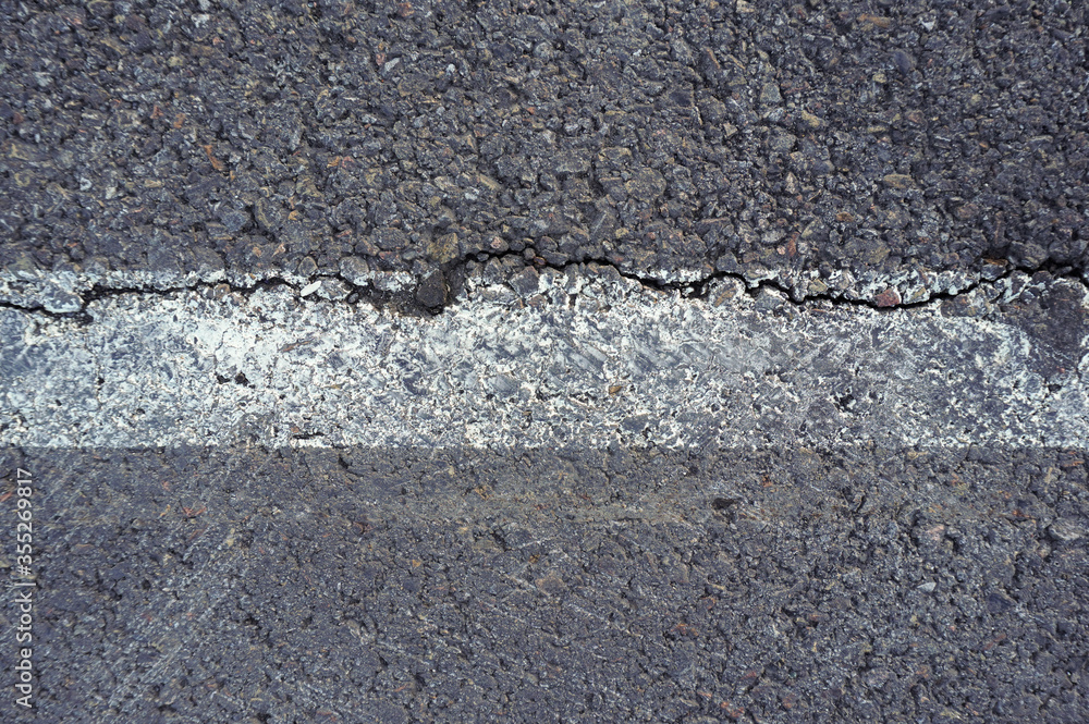 Asphalt texture with white line and tire marks. Smooth asphalt road. Tarmac dark grey grainy road background.Top view Asphalt texture with white line and tire marks. Smooth asphalt road. Tarmac dark grey grainy road background.Top view