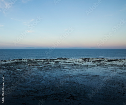 Seascape. Panorama view of the ocean water at sunset. 