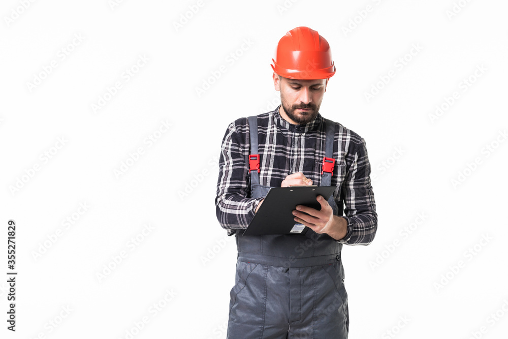 Young man contractor writing down details of an order isolated on white background Young man contractor writing down details of an order isolated on white background